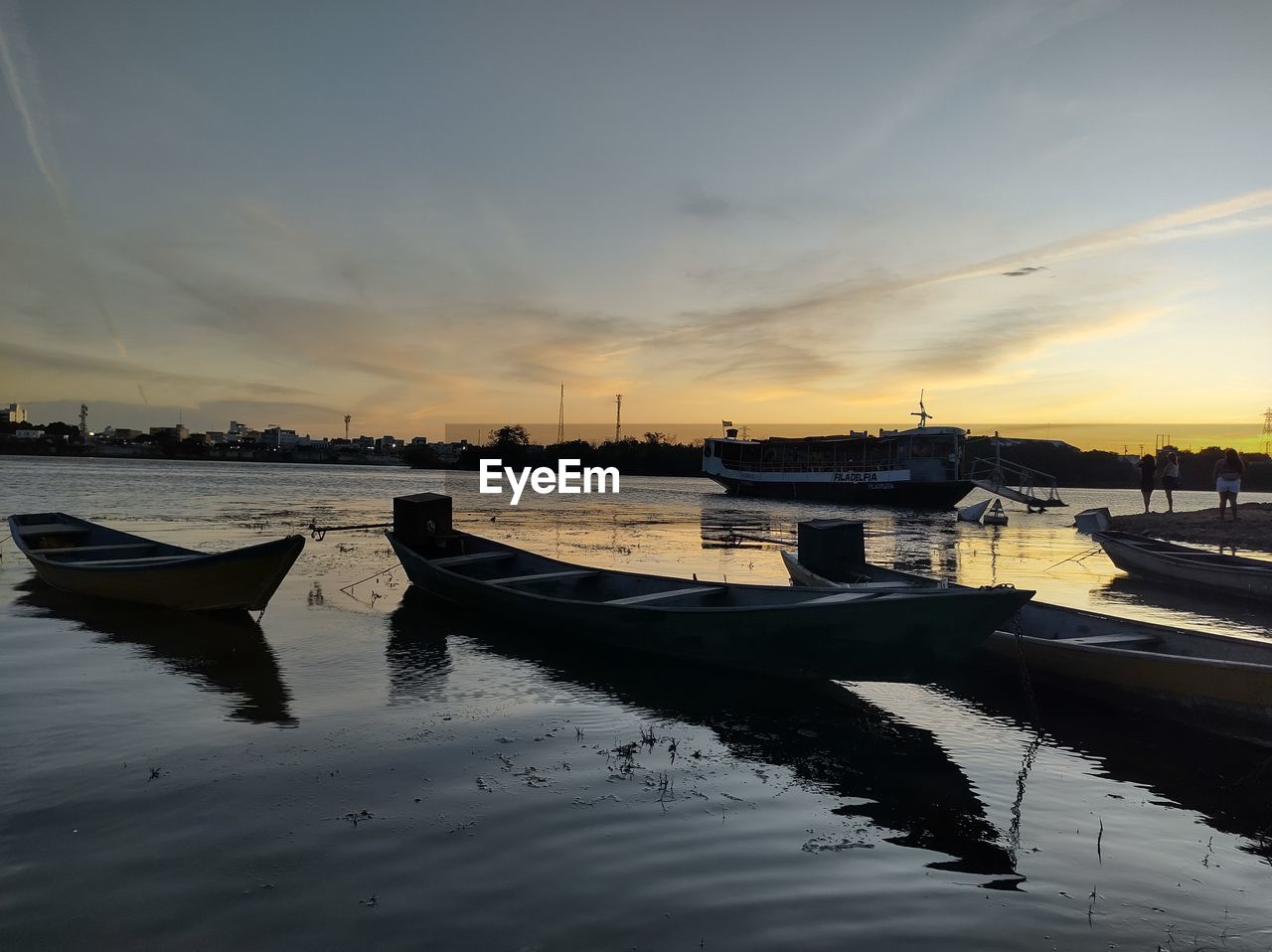 water, reflection, sky, nautical vessel, transportation, sunset, sea, nature, cloud, mode of transportation, evening, vehicle, dusk, architecture, beauty in nature, tranquility, scenics - nature, no people, travel destinations, boat, dock, wave, tranquil scene, travel, outdoors, ocean, built structure, ship, moored, city, land, pier, environment, horizon, shore, harbor, beach, landscape, sunlight, building exterior