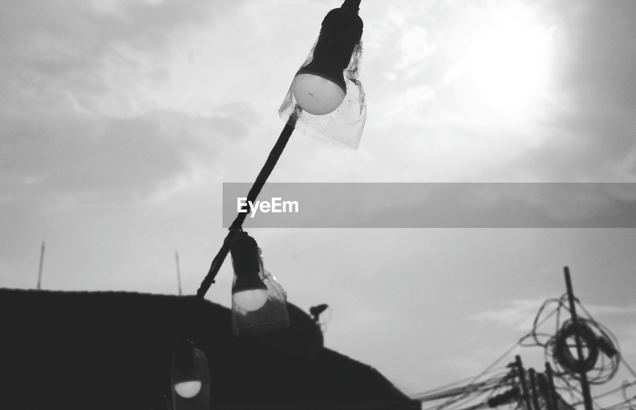 LOW ANGLE VIEW OF MAN ON MOTORCYCLE AGAINST SKY