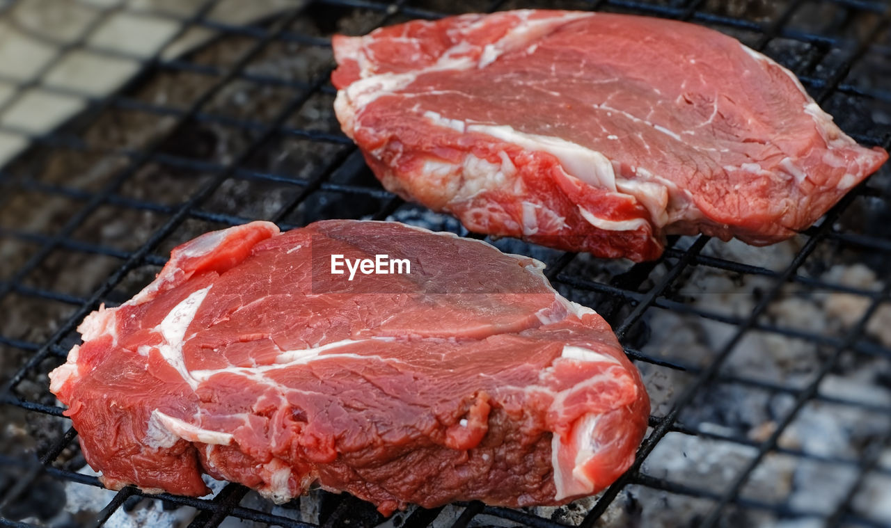 High angle view of meat on barbecue grill