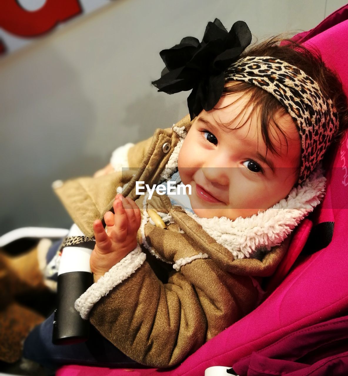 High angle portrait of baby girl sitting in stroller