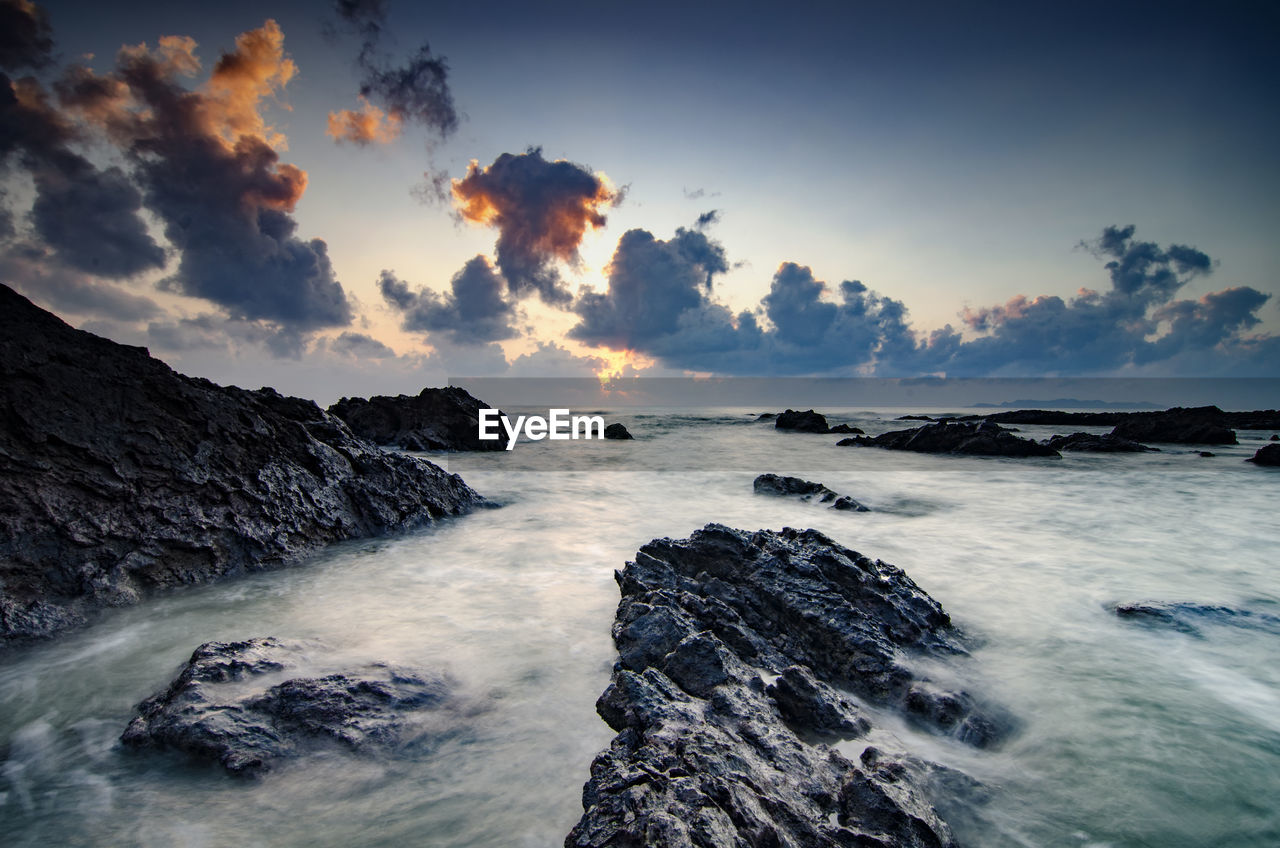 Scenic view of sea against sky at sunset