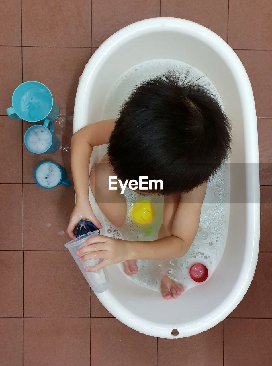 High angle view of child in bathtub