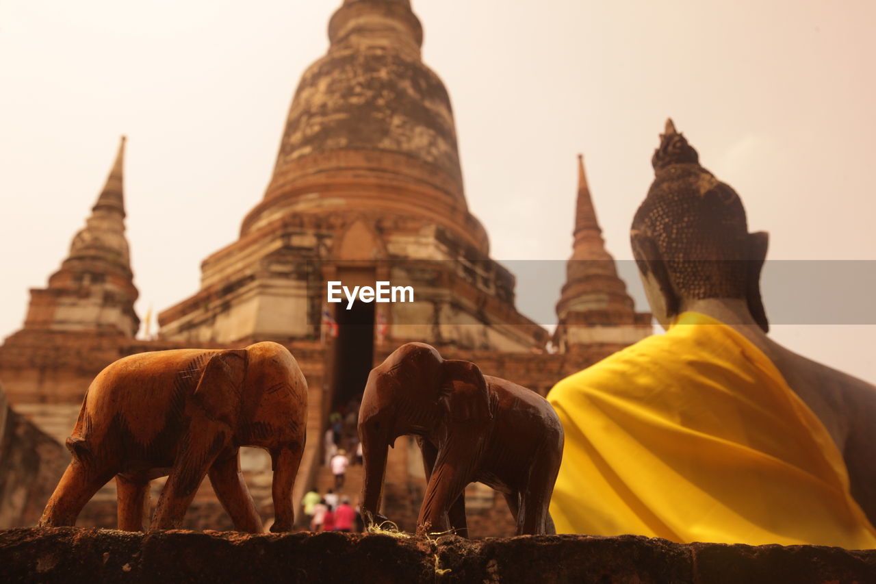 Elephant figurines by buddha statue and temple at ayutthaya kingdom