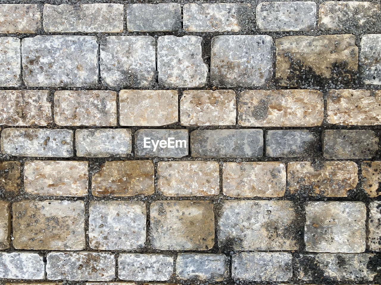 backgrounds, full frame, pattern, stone wall, textured, wall, no people, cobblestone, brick, brickwork, road surface, flooring, floor, architecture, wall - building feature, repetition, built structure, day, rough, stone material, outdoors, close-up, gray, footpath, shape, in a row, high angle view