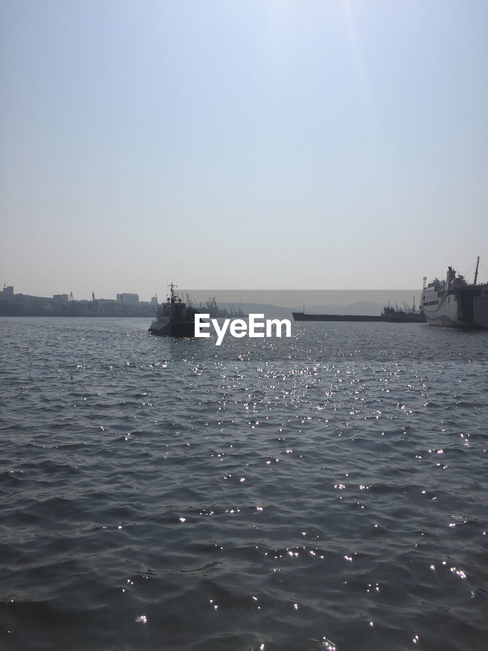 BOATS MOORED IN SEA