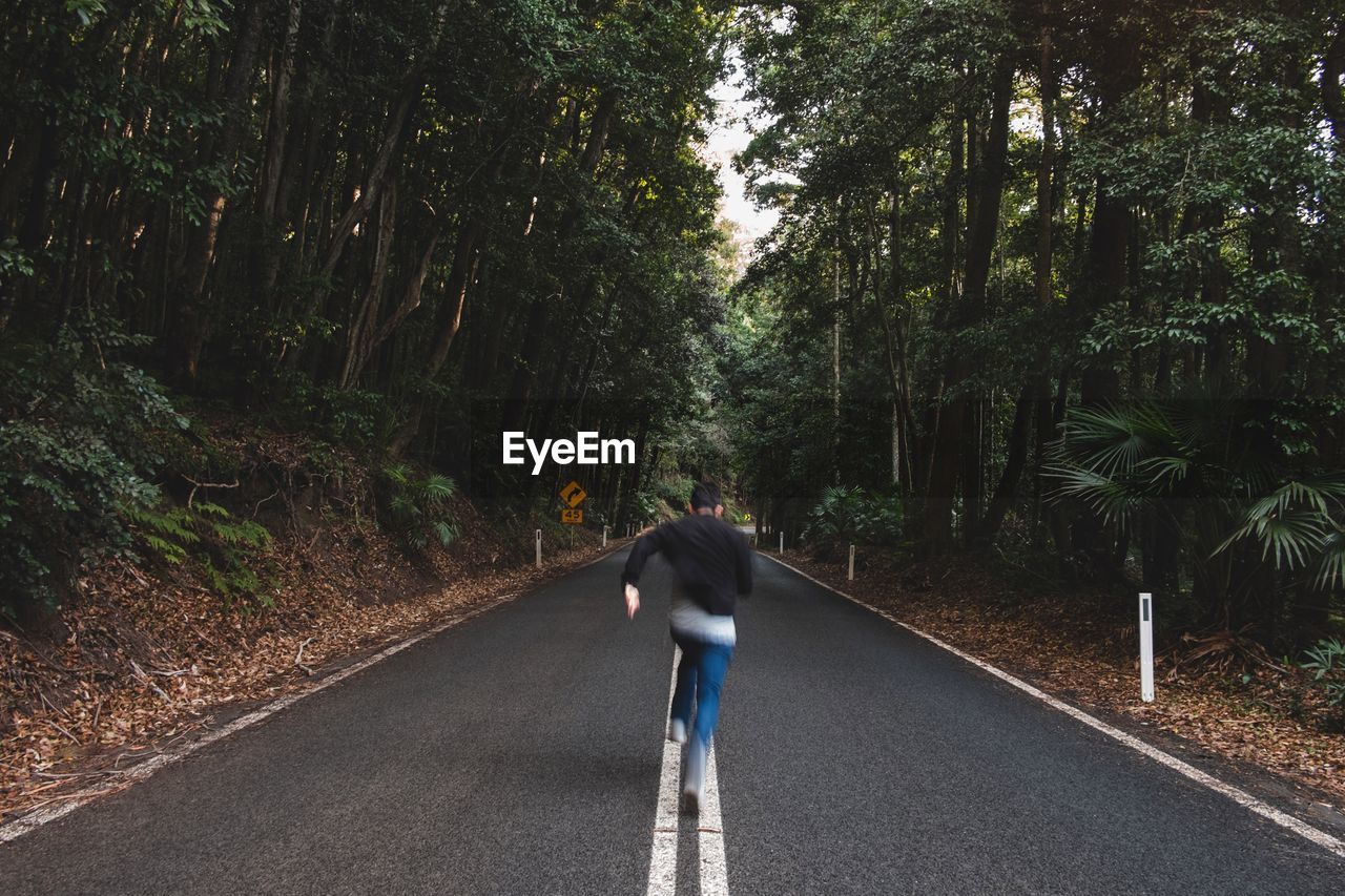 WOMAN WALKING ON ROAD