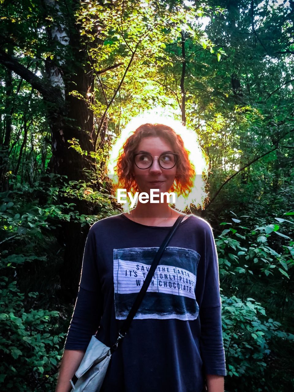 PORTRAIT OF BEAUTIFUL YOUNG WOMAN IN FOREST