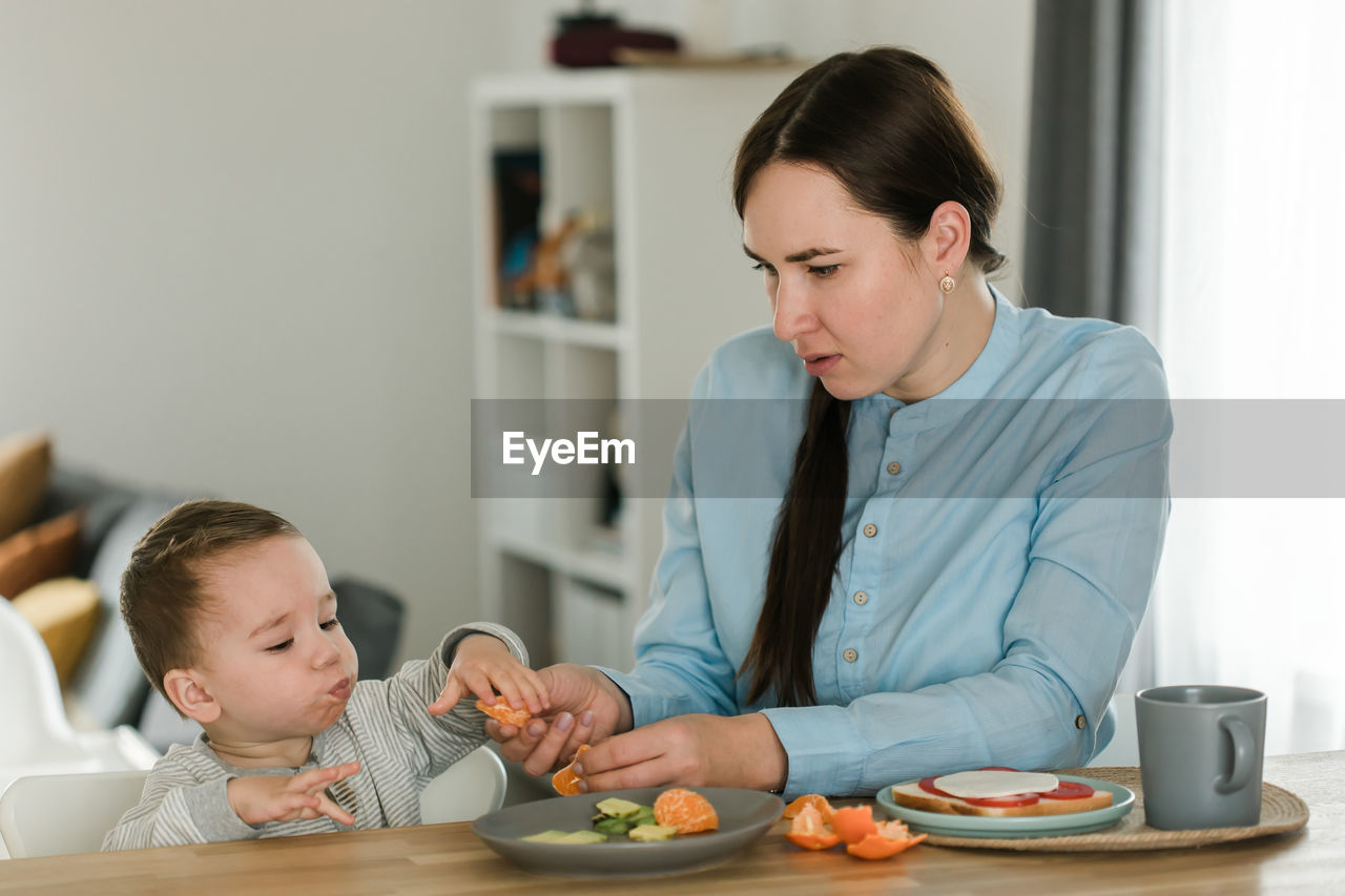 mother and daughter preparing food at home