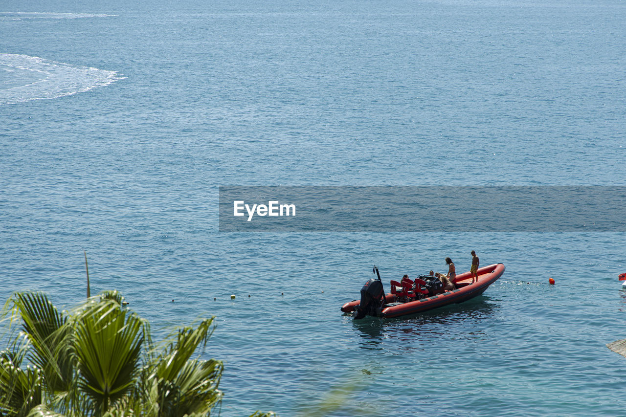 HIGH ANGLE VIEW OF PEOPLE ON SEA