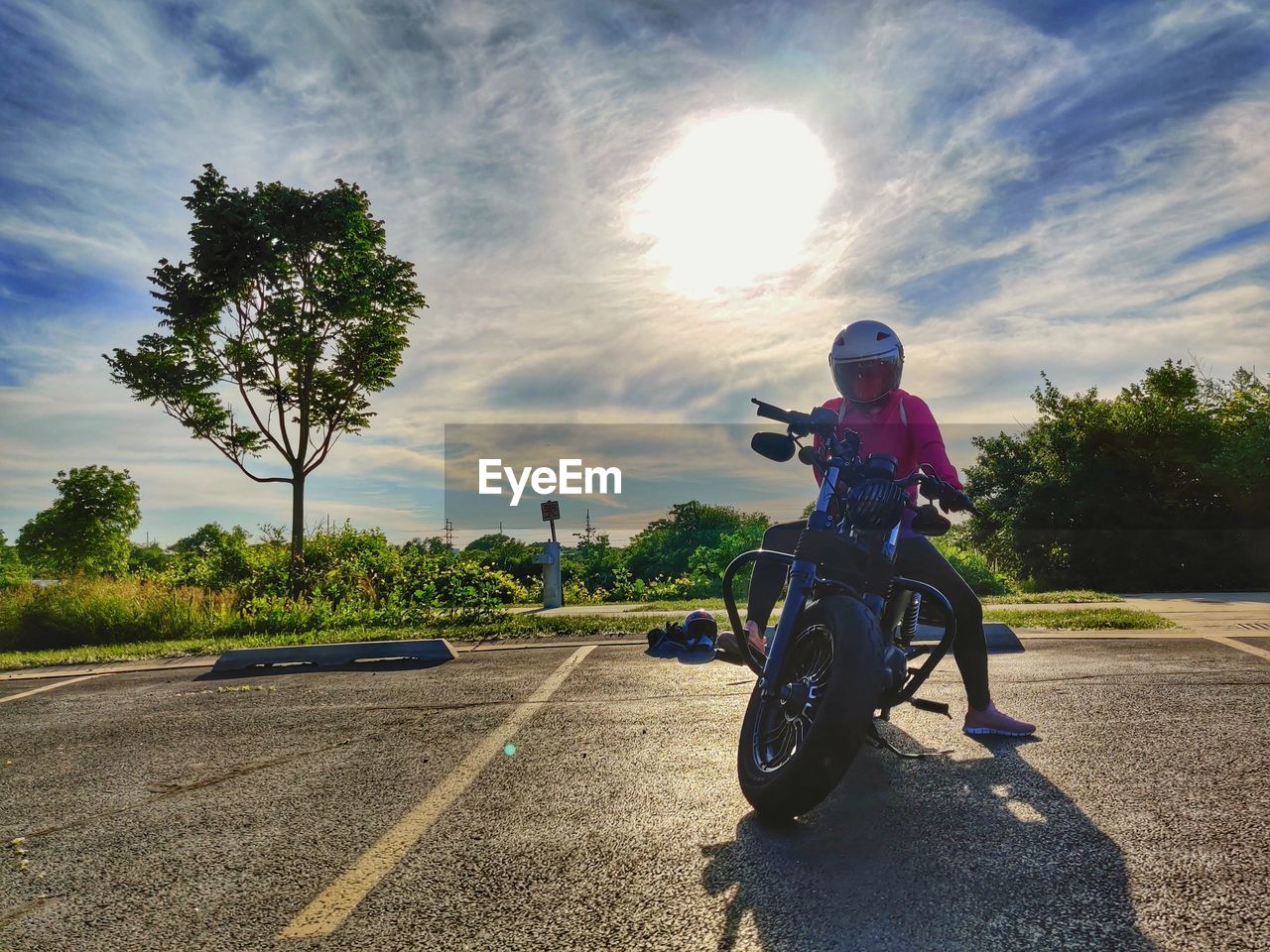 MAN RIDING MOTORCYCLE AGAINST SKY