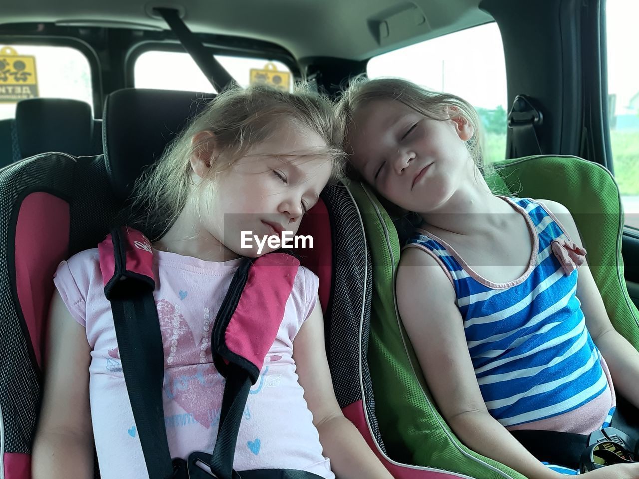 Girl sitting in car. children sleep in car seats