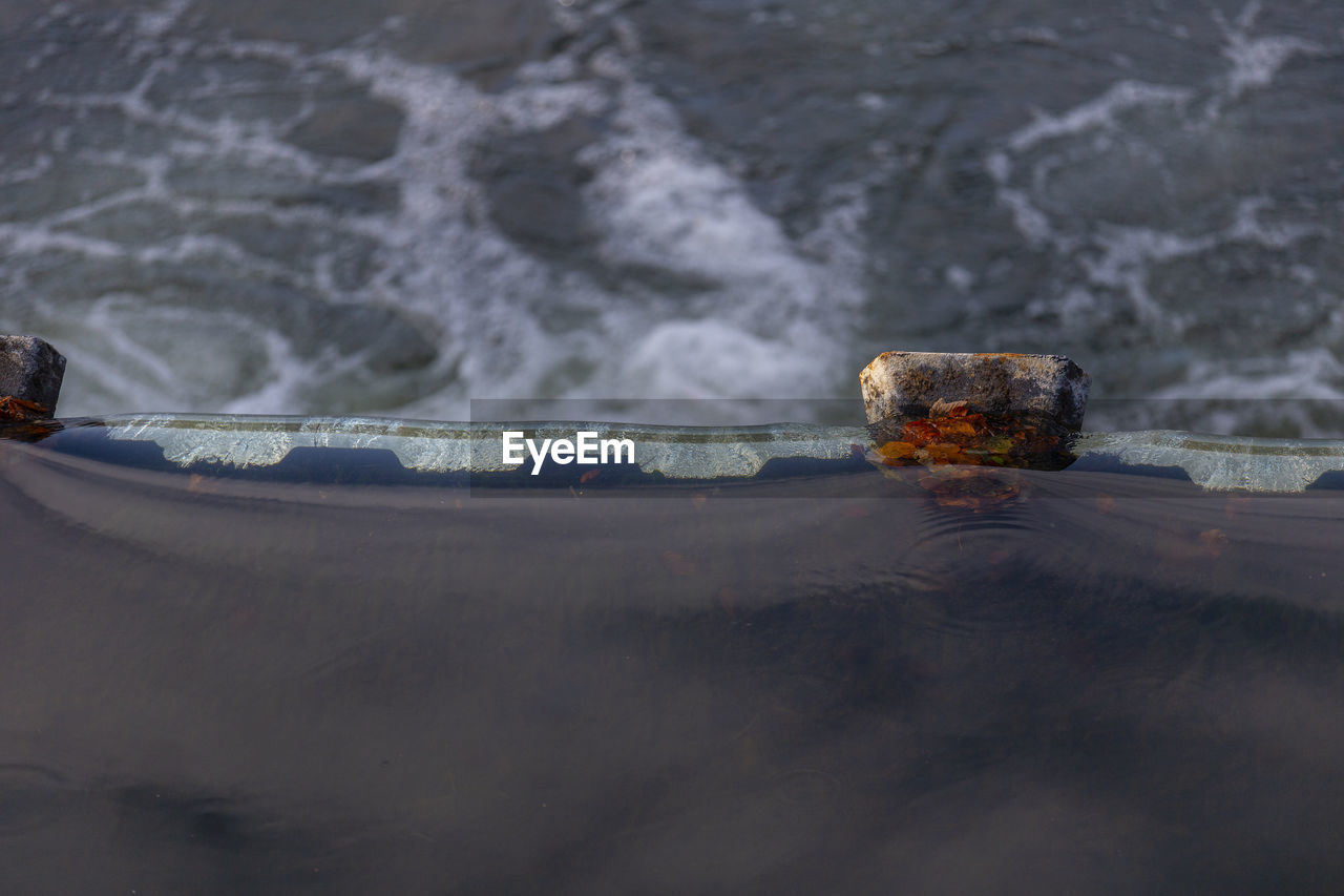 CLOSE-UP OF ABANDONED BOAT ON SHORE