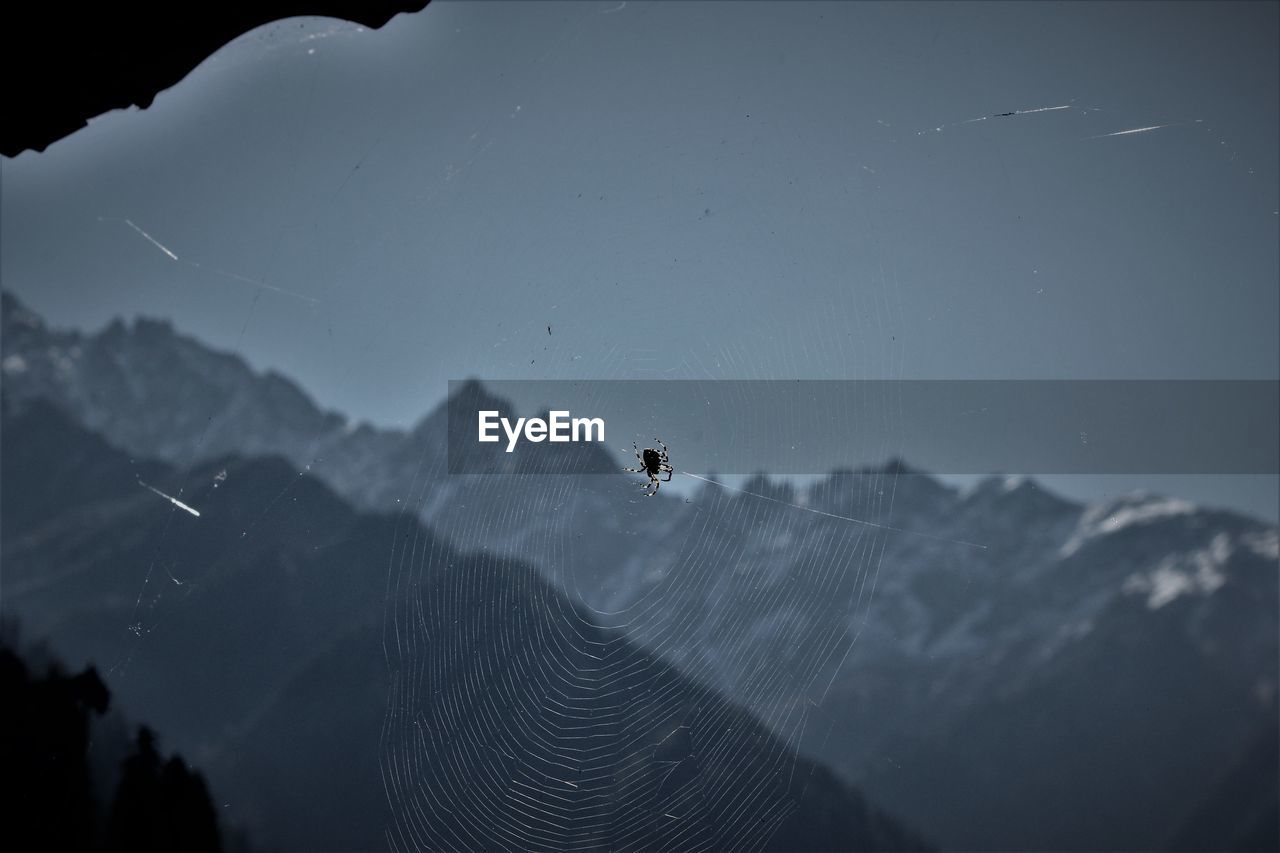 LOW ANGLE VIEW OF SKY OVER MOUNTAINS AGAINST THE BACKGROUND