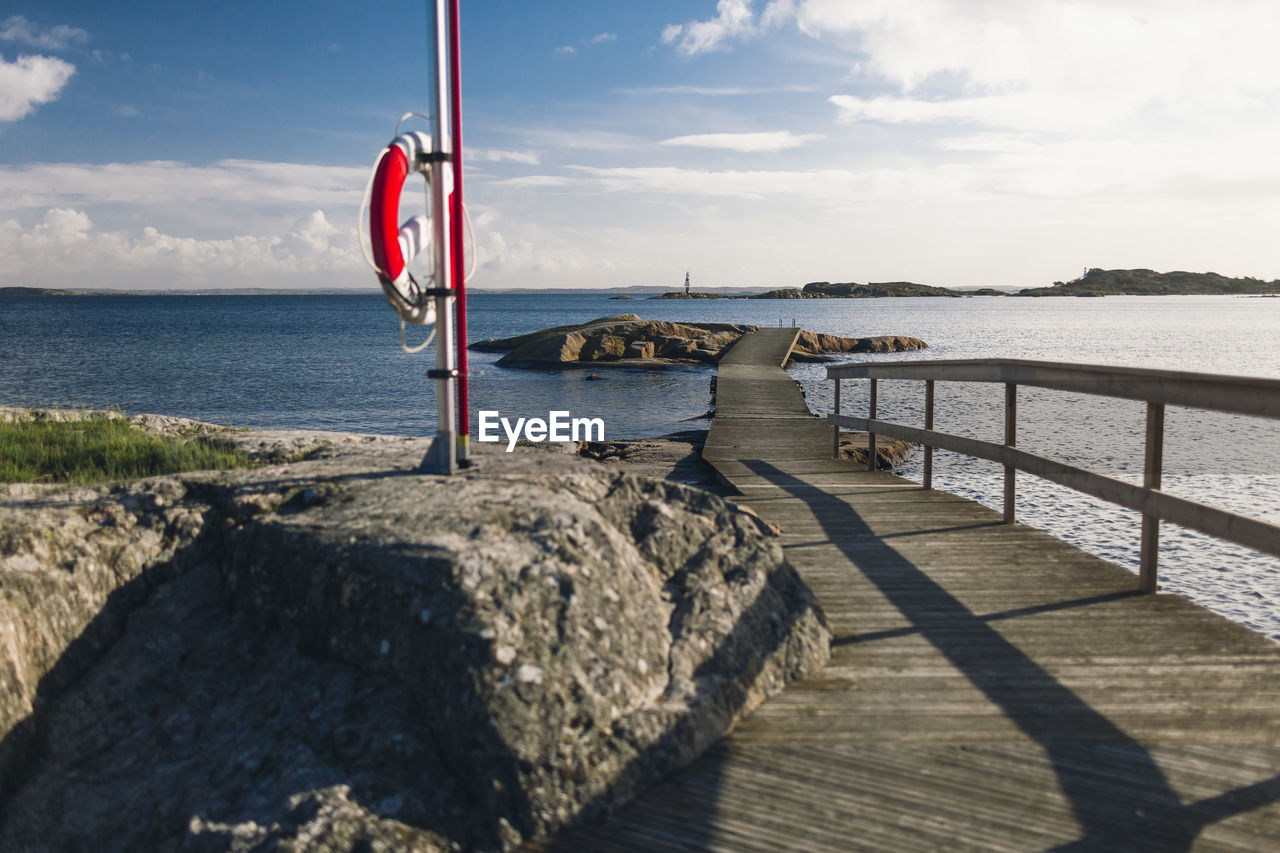 Jetty and life ring at fjord