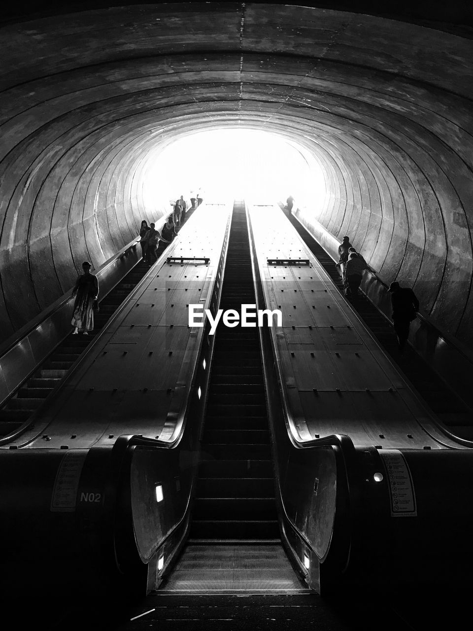 Low angle view of people on escalator at subway station