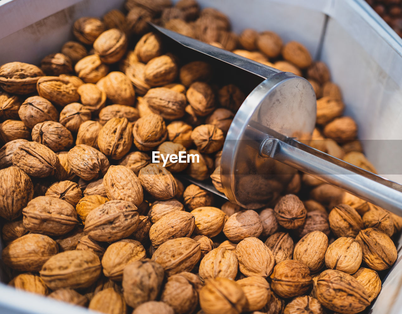 Close-up of nuts in container for sale 