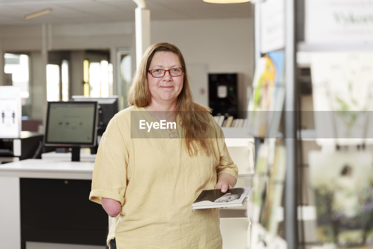 Portrait of librarian holding a book