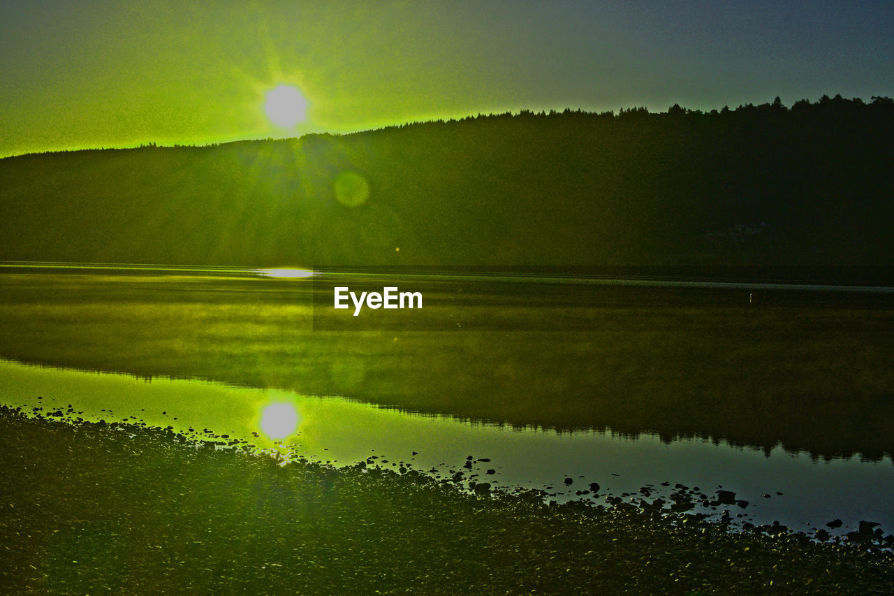 Scenic view of lake against sky during sunset