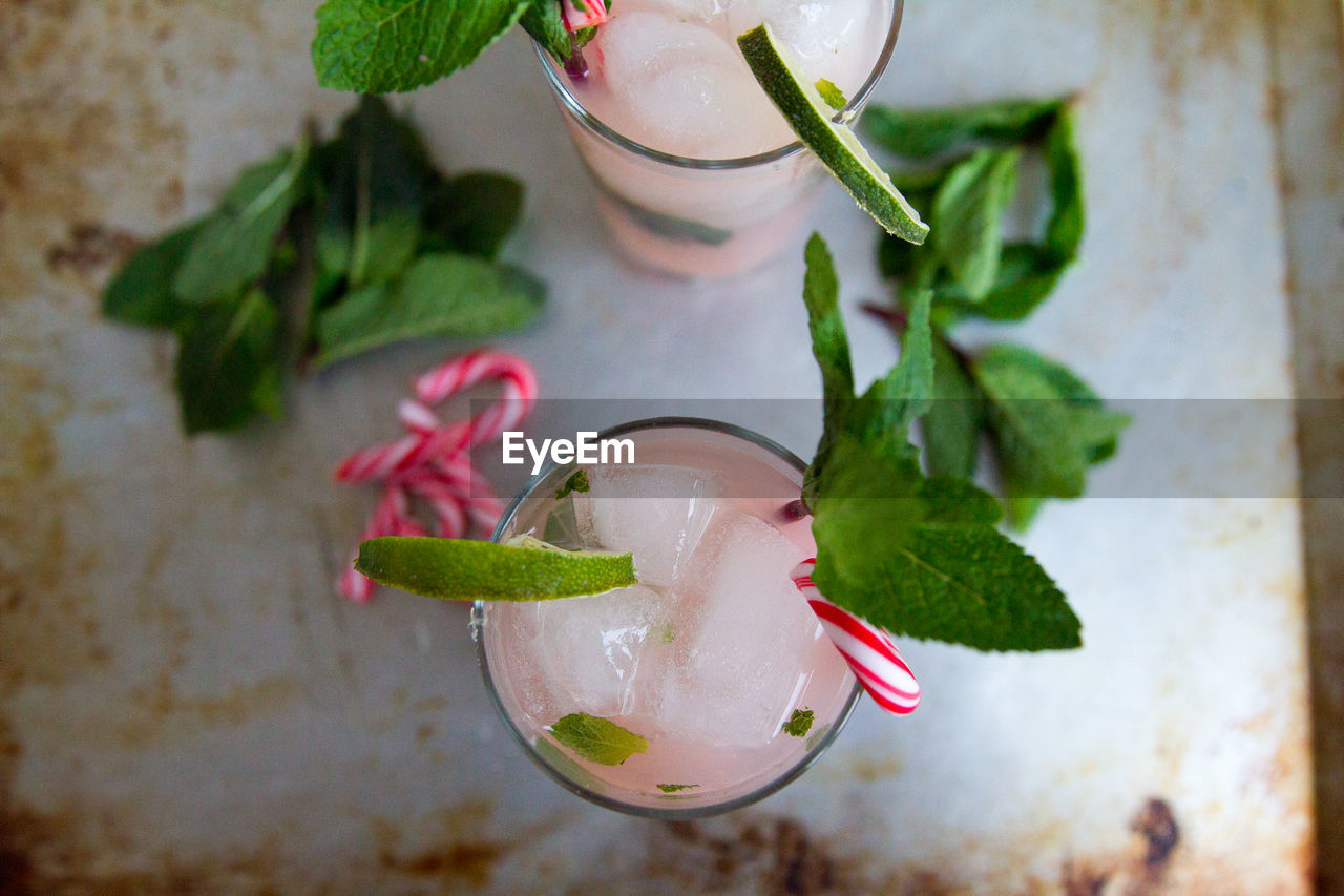 Directly above shot of cocktail served on table with mint