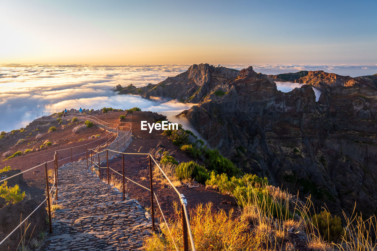 SCENIC VIEW OF MOUNTAINS AND SEA AGAINST SKY