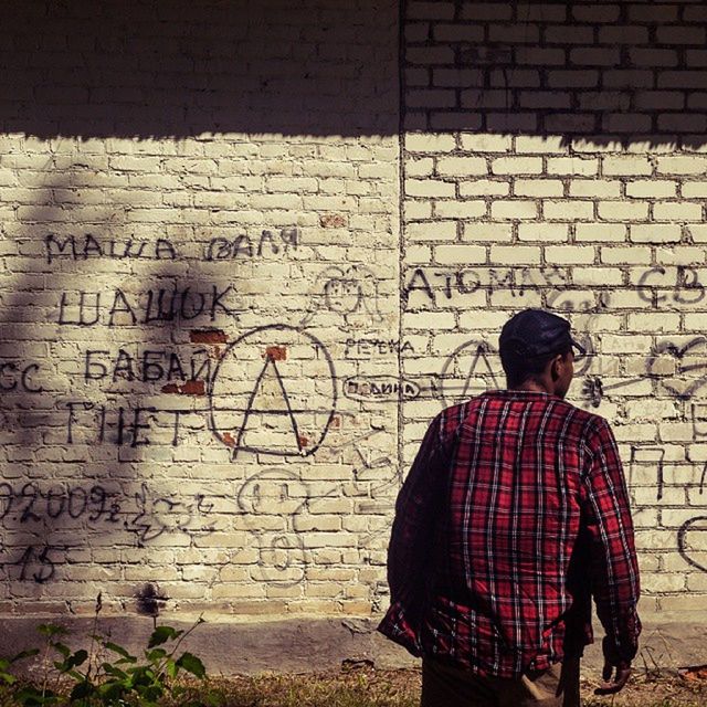 MAN STANDING ON WALL