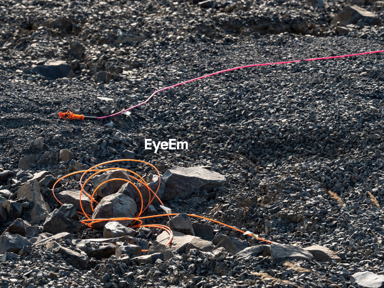 Explosive works in quarry, drilled rock stuffed with explosives ignition lines. holes in basalt mine