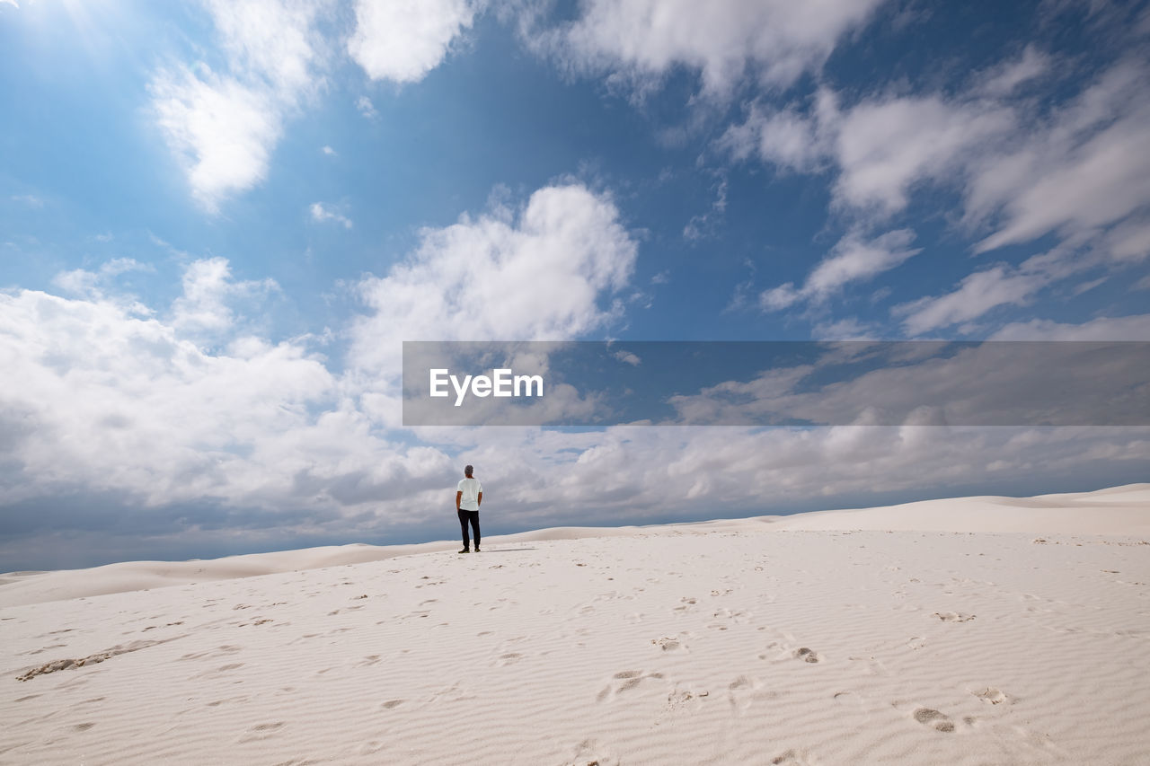 Full length of man standing on desert against sky