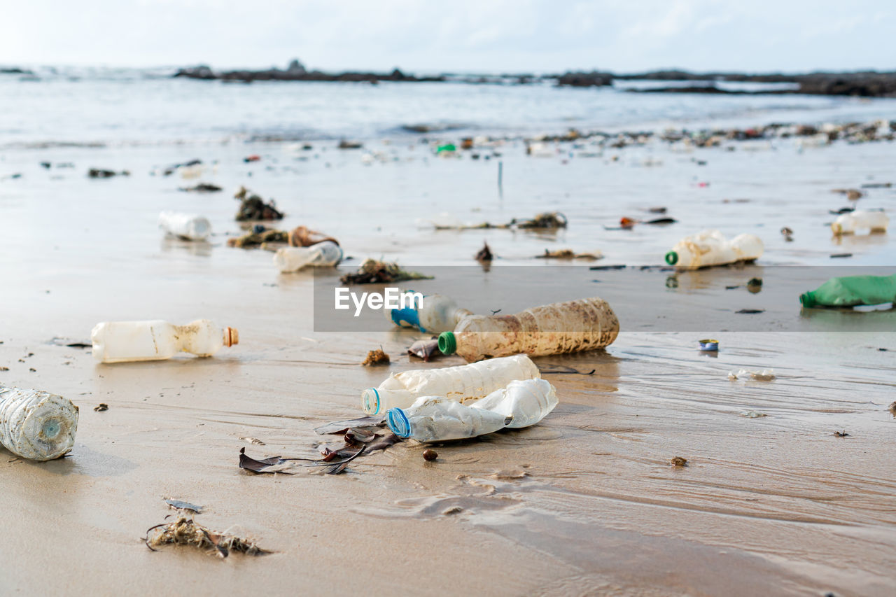 VIEW OF GARBAGE ON BEACH