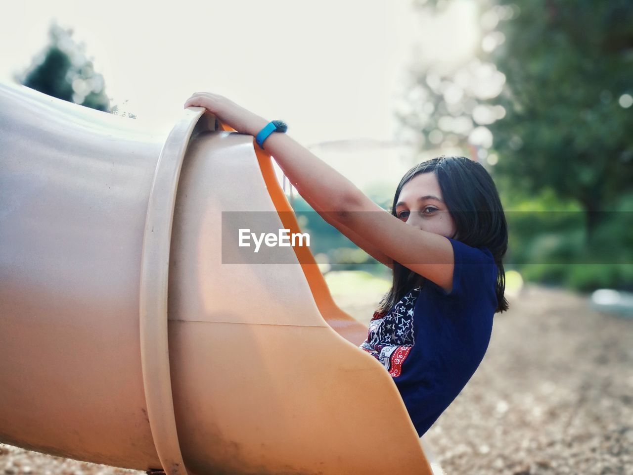 Girl playing in outdoor play equipment