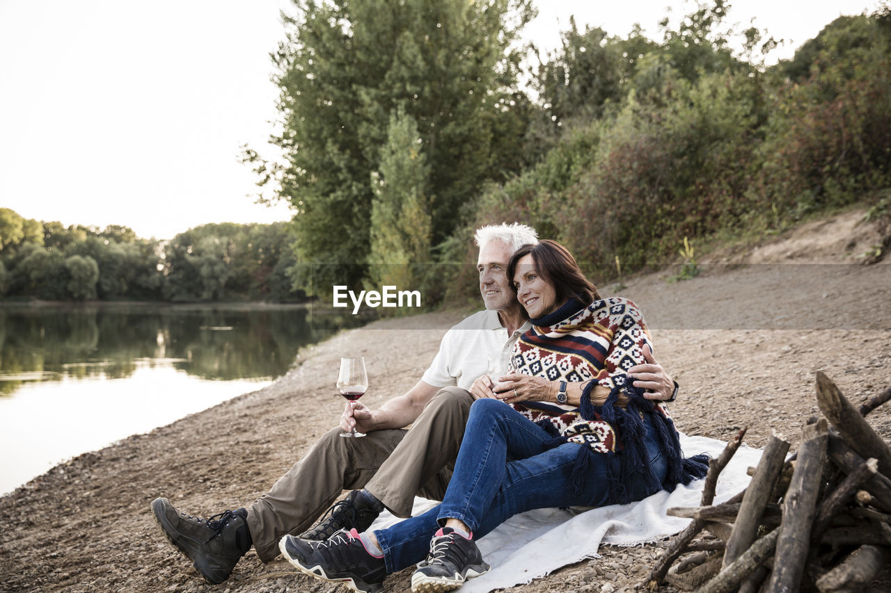 Relaxed senior couple at a lake in the evening
