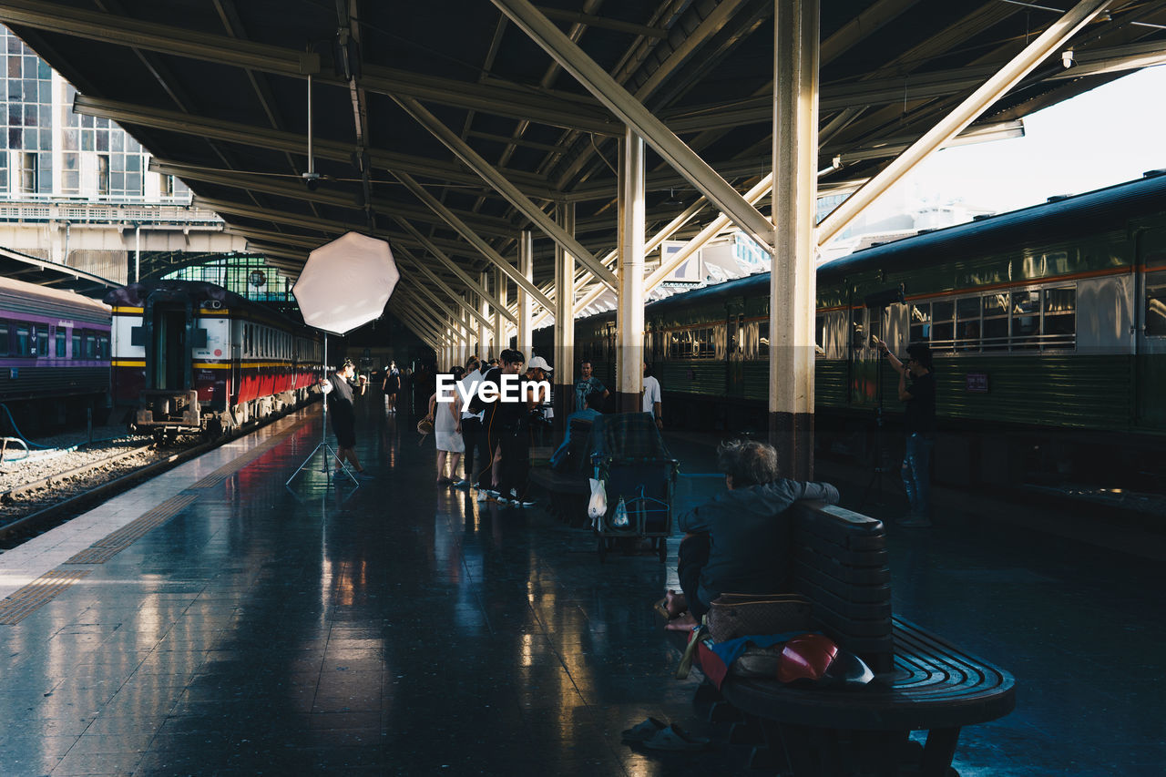 GROUP OF PEOPLE AT RAILROAD STATION