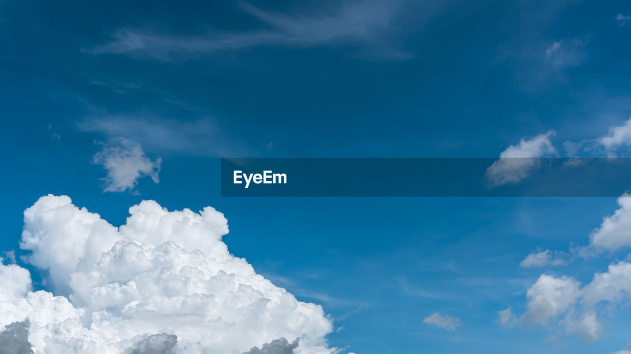 LOW ANGLE VIEW OF WHITE CLOUDS IN BLUE SKY