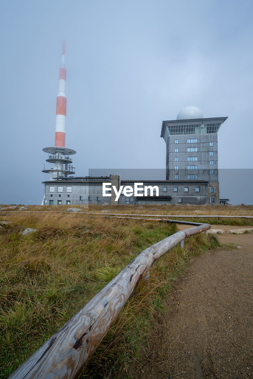 Brocken, top of highest mountain in harz with wooden railing in foreground