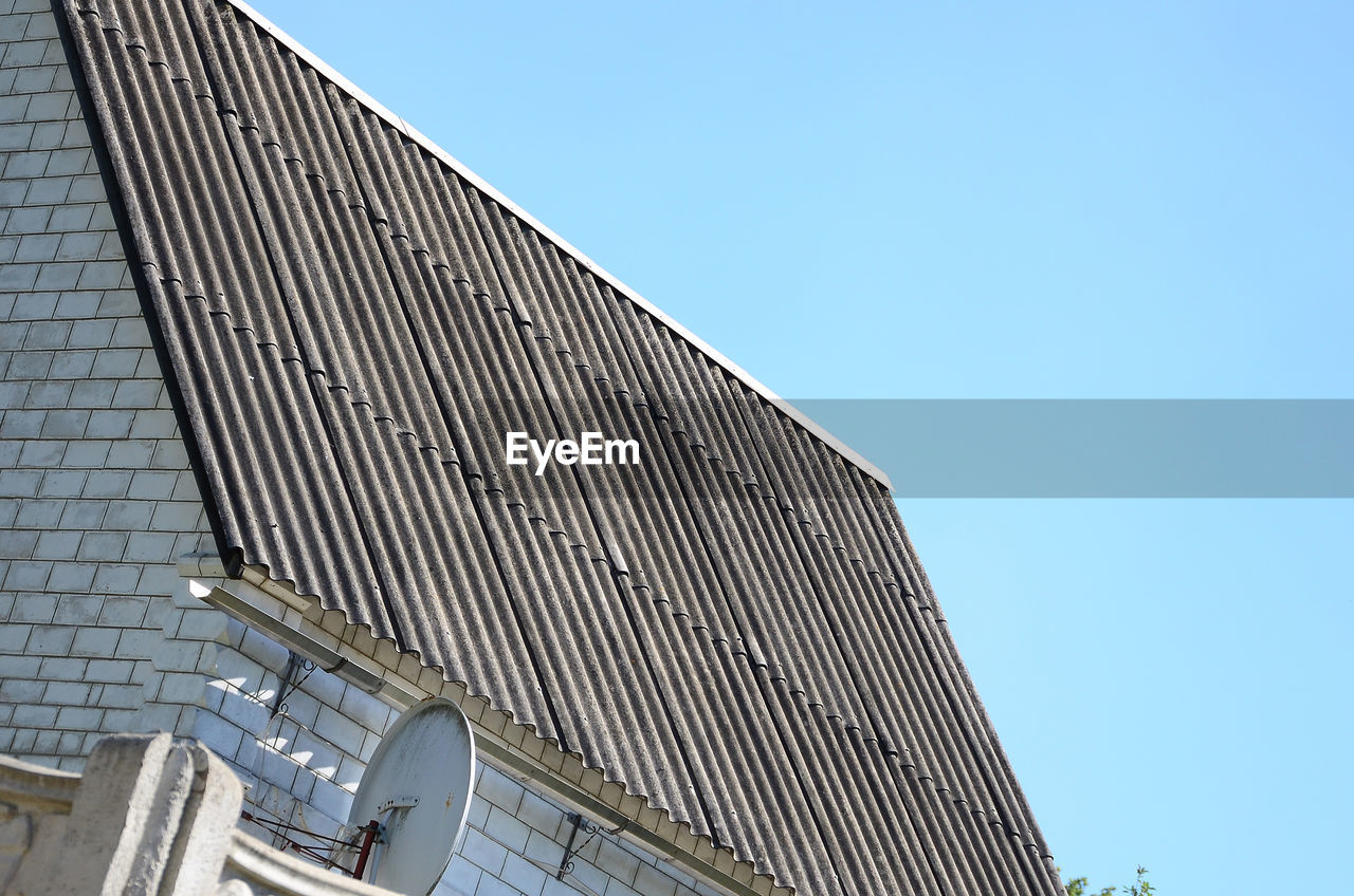 Low angle view of modern building against clear blue sky