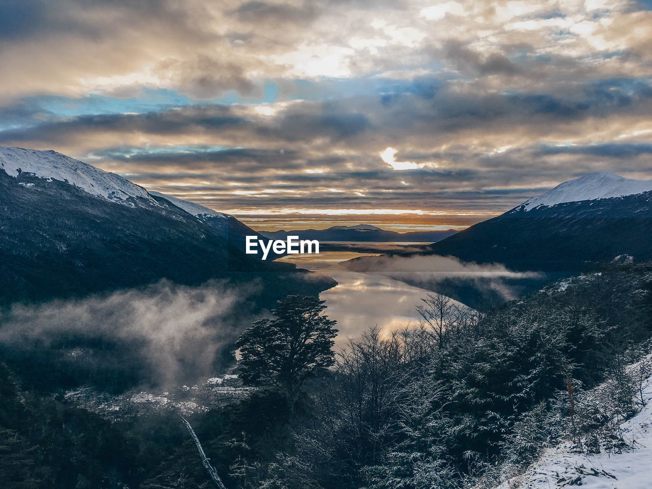 Scenic view of snowcapped mountains against sky during sunset