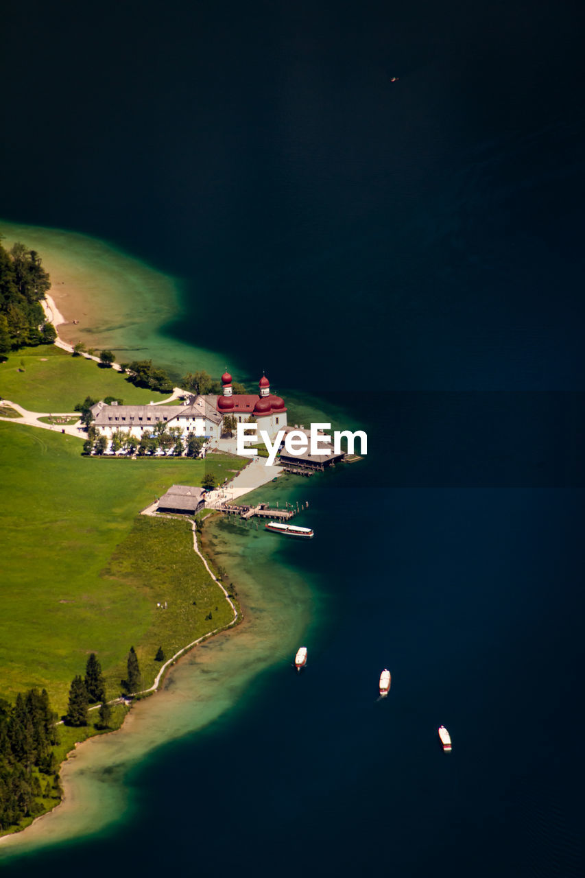 Aerial view of built structure by sea