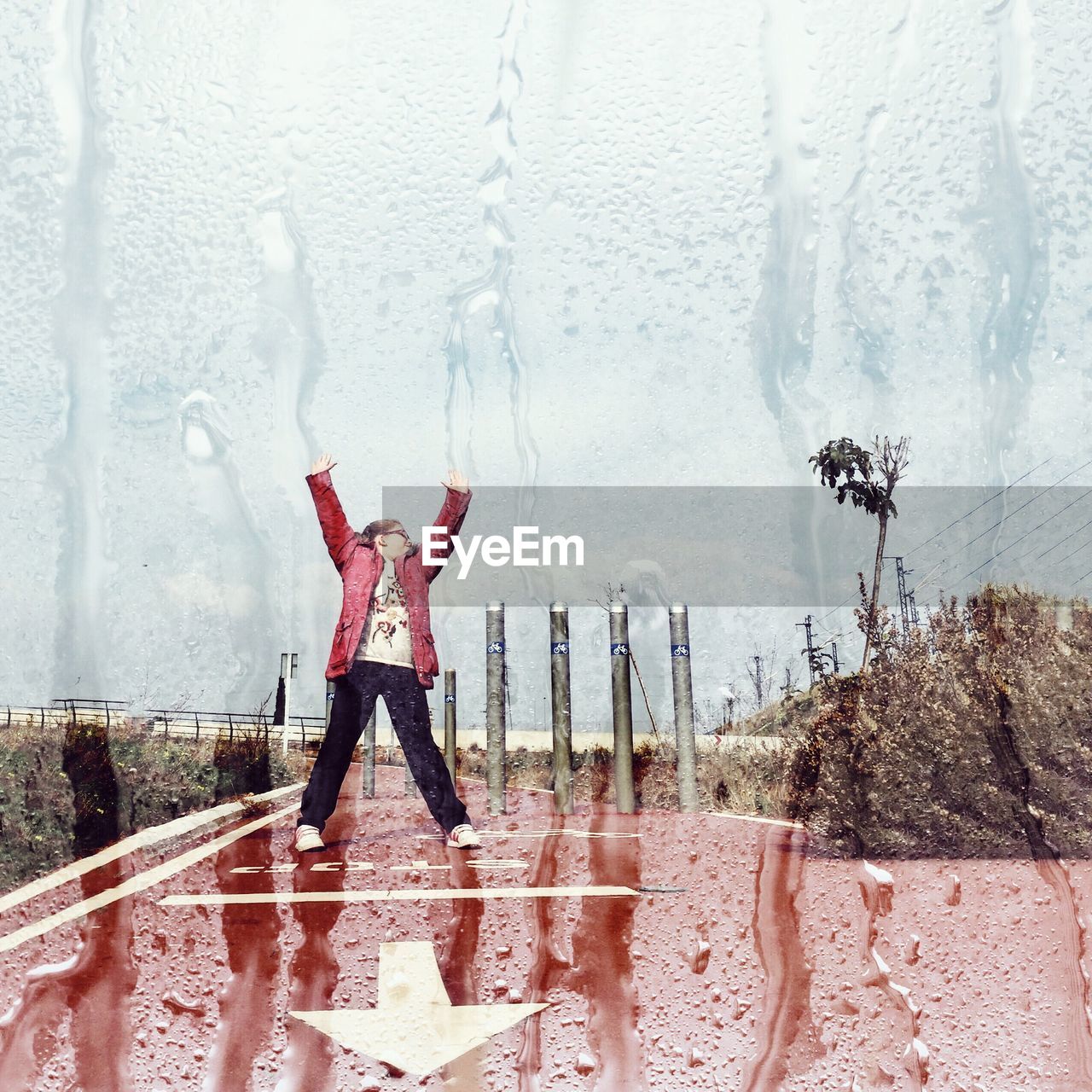 Double exposure image on girl standing on wet footpath and condensed glass