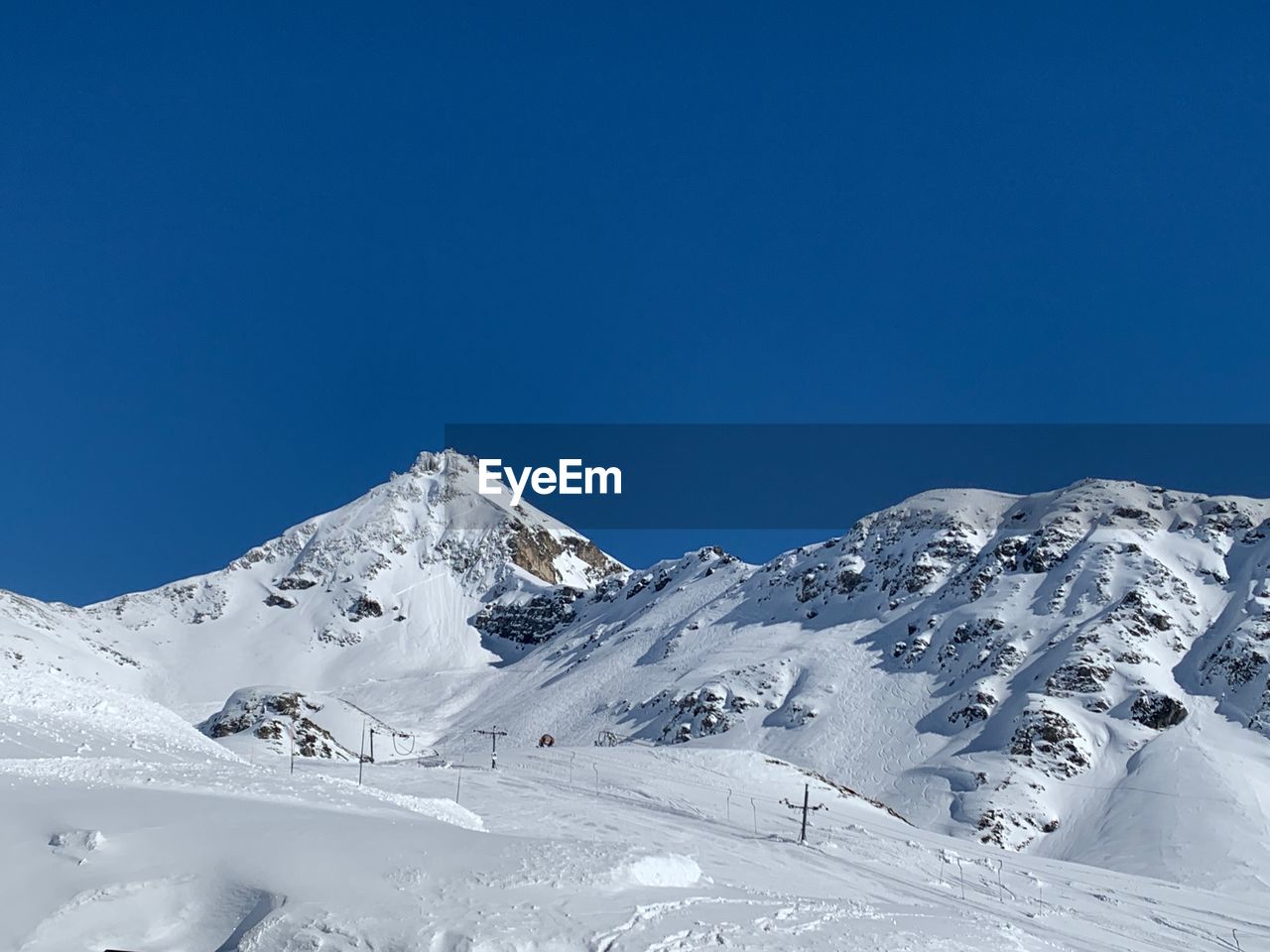 SNOWCAPPED MOUNTAINS AGAINST BLUE SKY