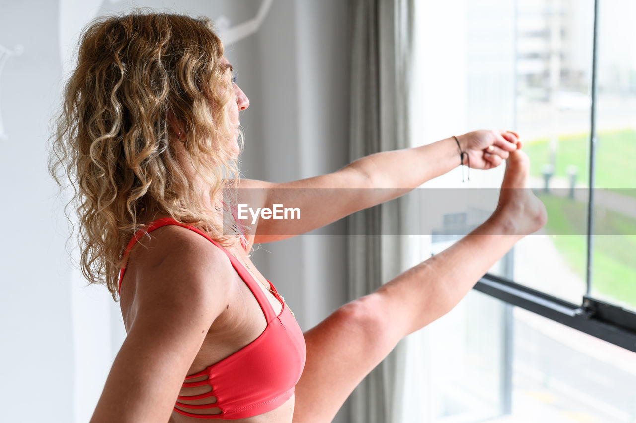 Side view of woman exercising in gym