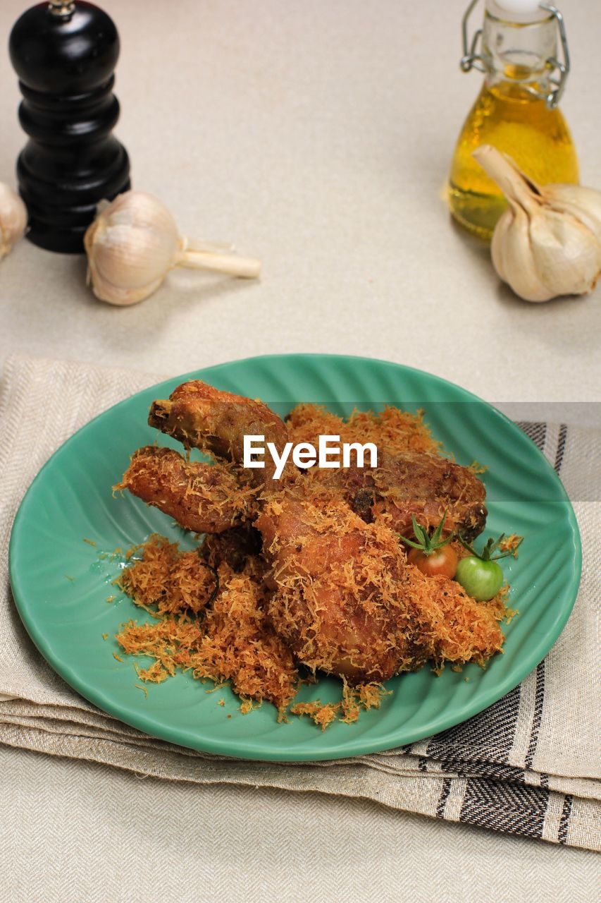 Ayam serundeng, indonesian traditional fried chicken recipe with shredded coconut.