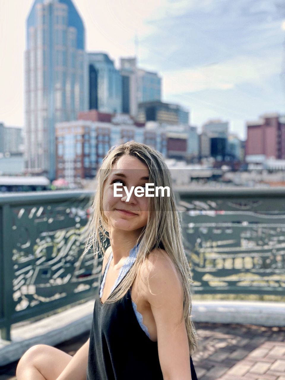 Portrait of smiling young woman in city