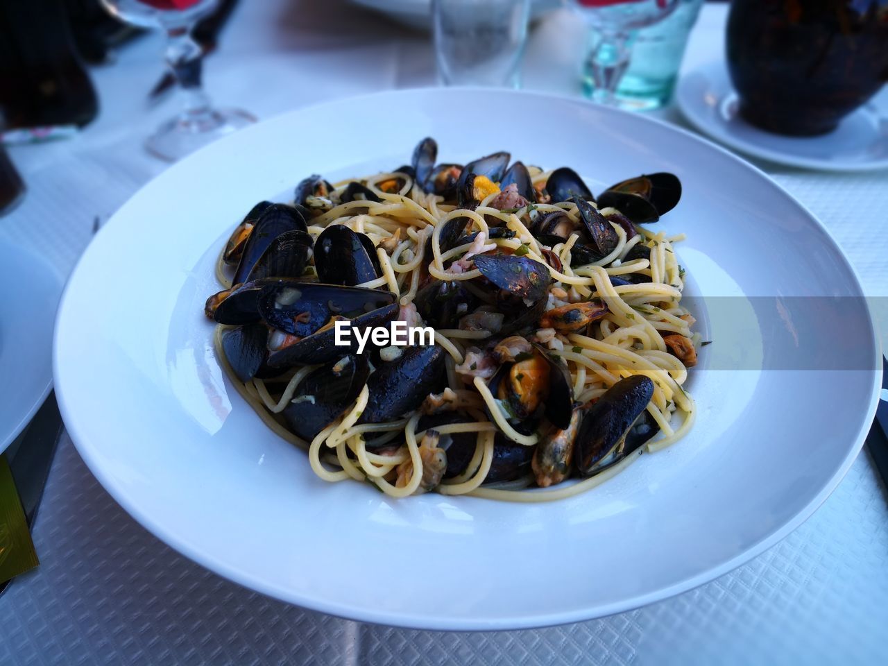 Close-up of spaghetti with clams in plate on table