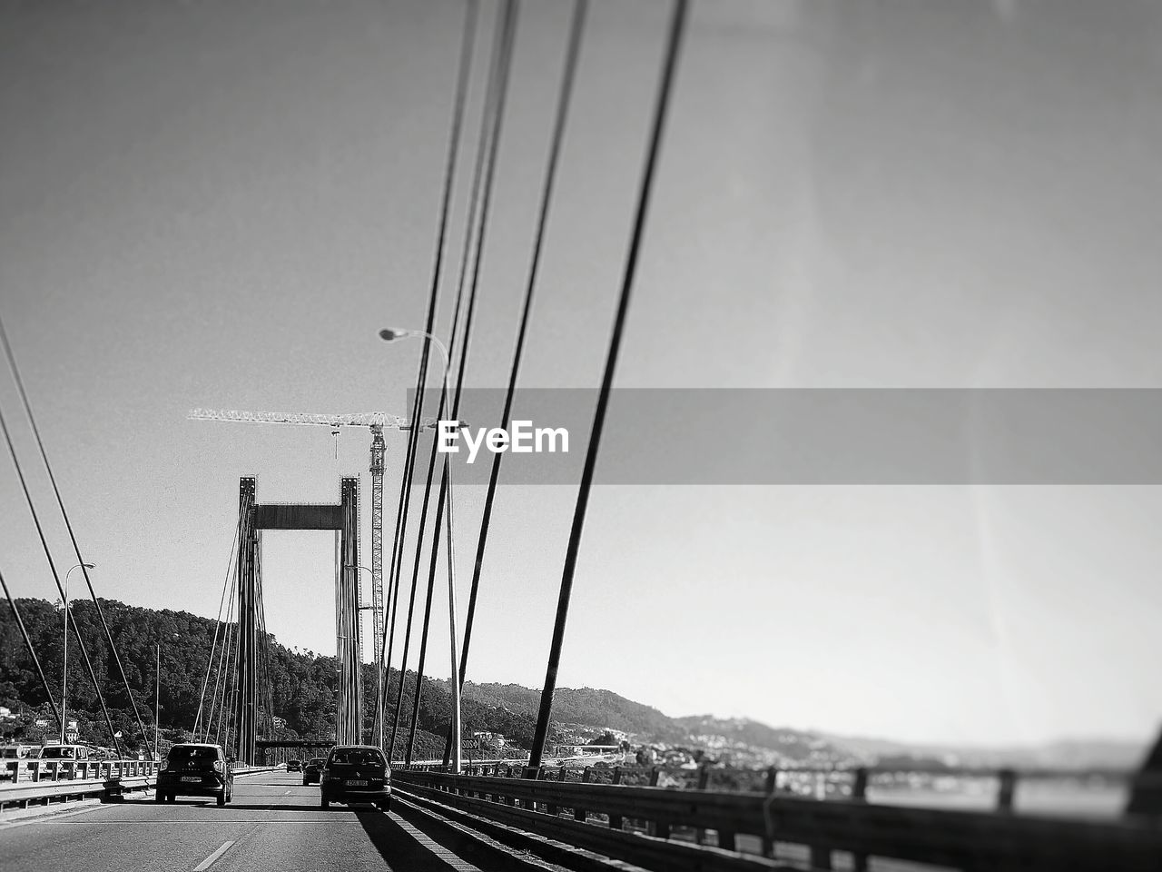 SUSPENSION BRIDGE OVER RIVER AGAINST SKY