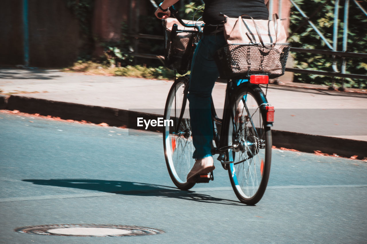 Woman riding bicycle on road