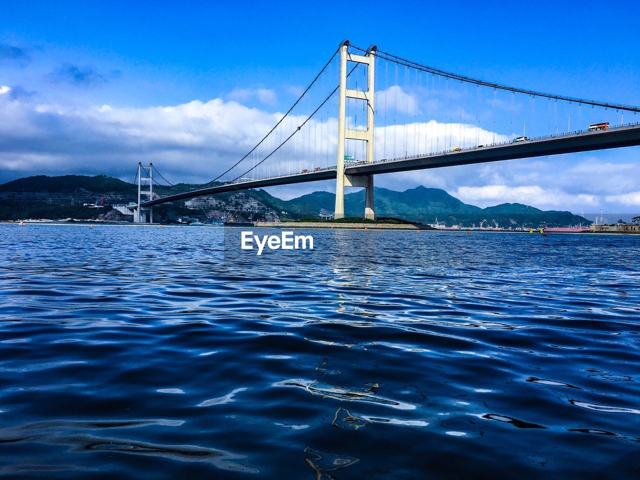 VIEW OF SUSPENSION BRIDGE IN RIVER