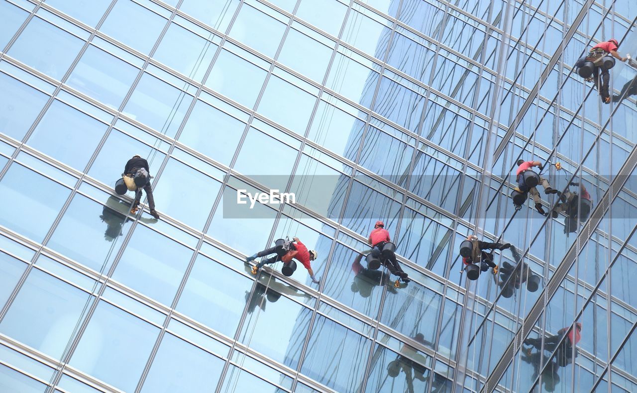 Low angle view of window cleaners