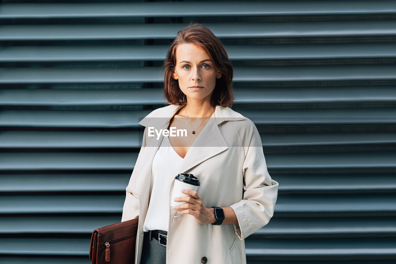 portrait of woman standing against wall