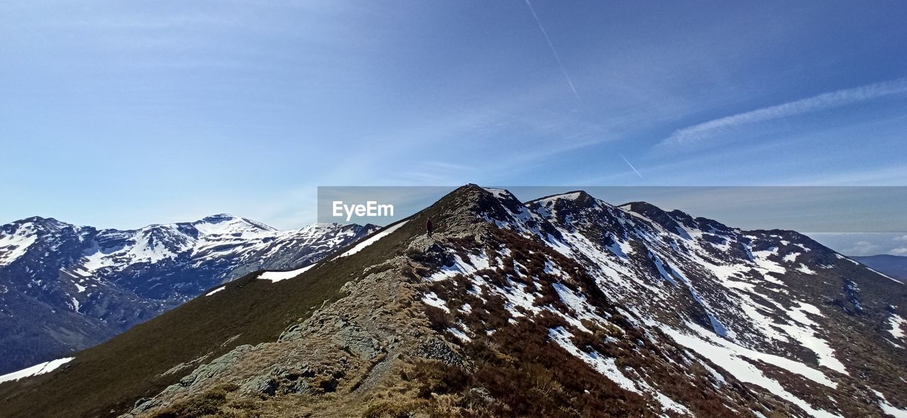 SCENIC VIEW OF SNOWCAPPED MOUNTAINS AGAINST SKY DURING WINTER