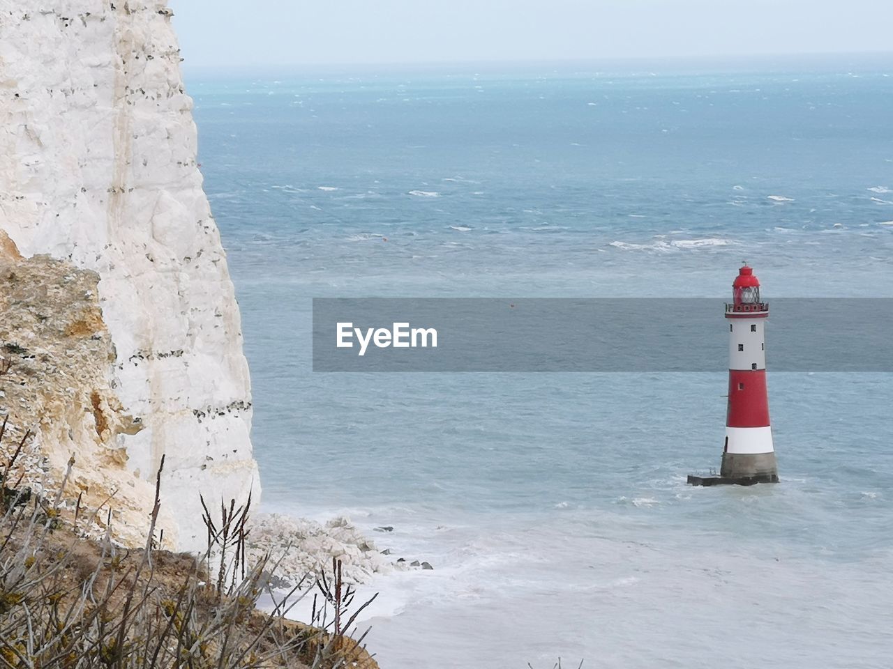 Lighthouse by cliffs