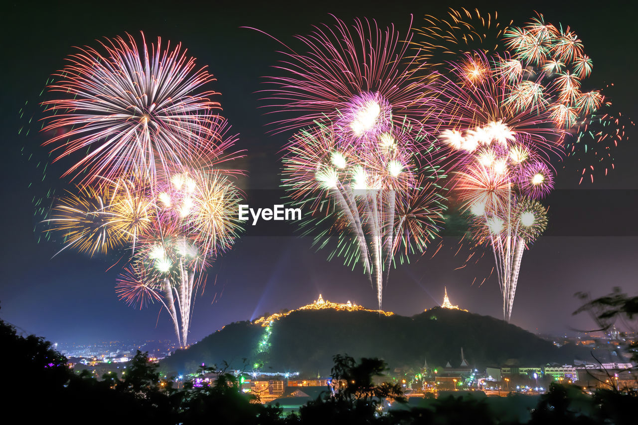 Low angle view of firework display at night